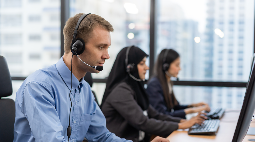 Customer Service team with headsets, responding to calls