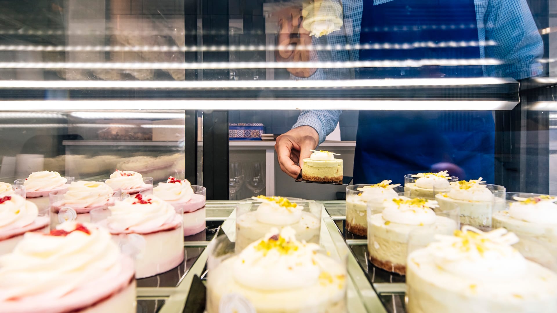 man getting cake from refrigerator
