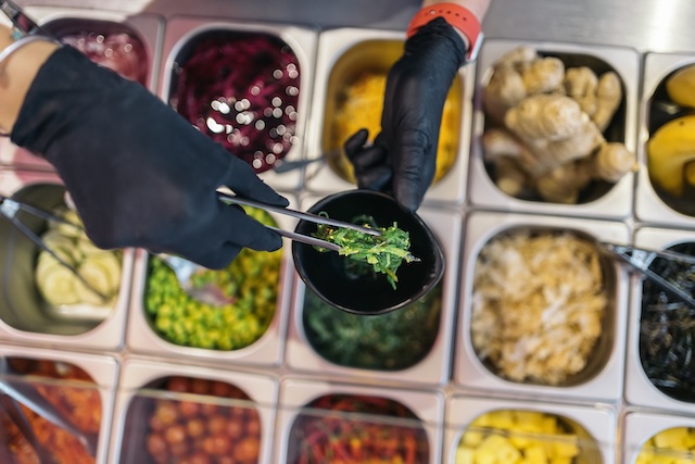 preparing poke bowl in restaurant