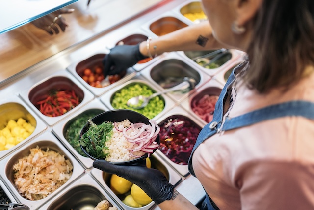 woman preparing poke bowl
