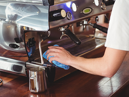 watiress cleaning coffee dispenser