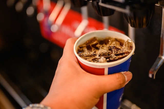 man pouring carbonated drink